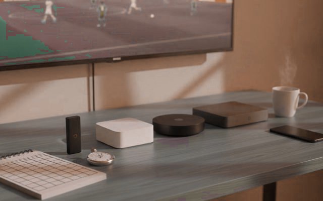 Five streaming devices, a notebook scoring grid and a stopwatch in front of a TV showing a football match
